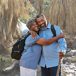 Two Seniors Hugging on a hike